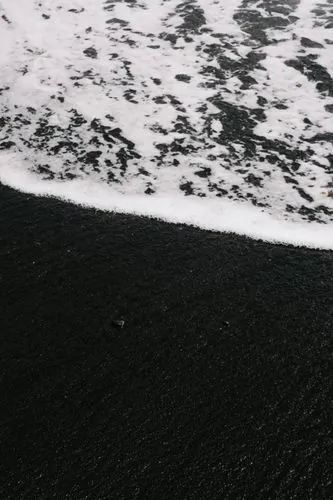 Black sand beach with ocean waves