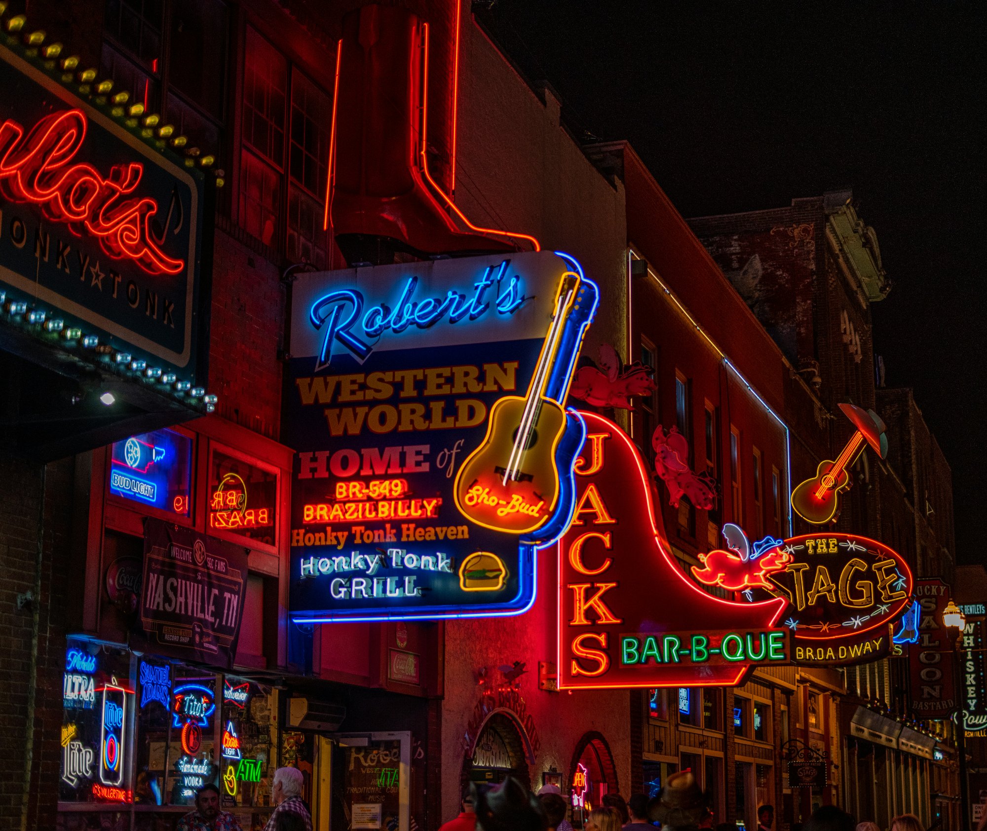 Neon signs on Lower Broadway including Robert's Western World and Jack's Bar-B-Que