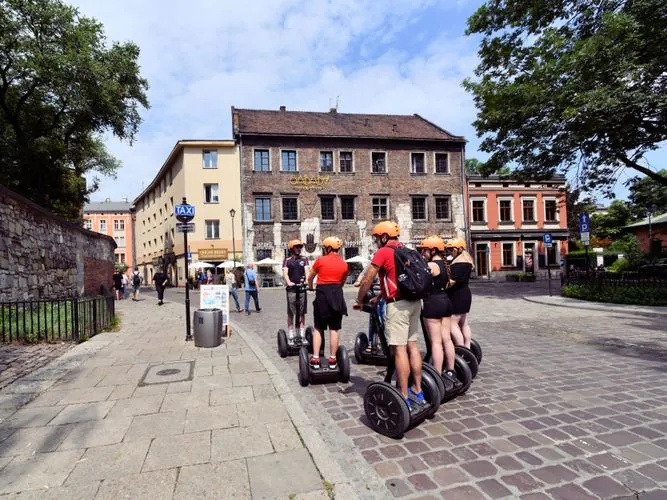 Tourists riding Segways on a city street